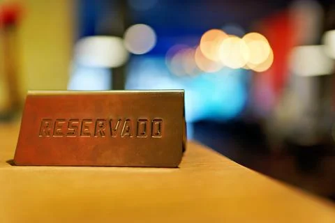 Reserved sign on a table in a restaurant setting. Stock Photos