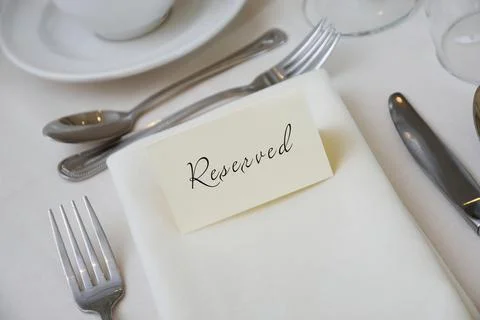 Reserved Sign at a Table Setting with White Tablecloth Stock Photos