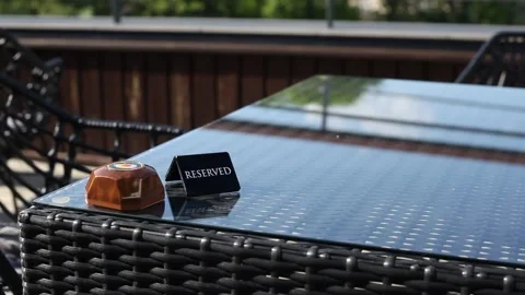 Reserved sign on the table. A tag of reservation placed on the wood table. Stock Footage 197523015