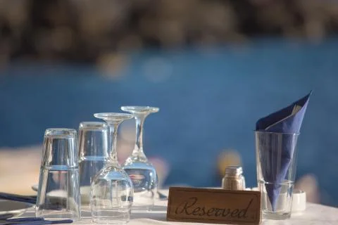 Reserved table in front of the aegean sea Stock Photos