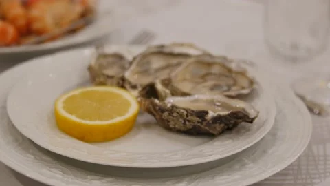 A reserved table in the restaurant in the evening, a close-up of oysters in the Video stock 145777886