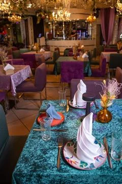 Reserved table in the restaurant for evening guests Stock Photos