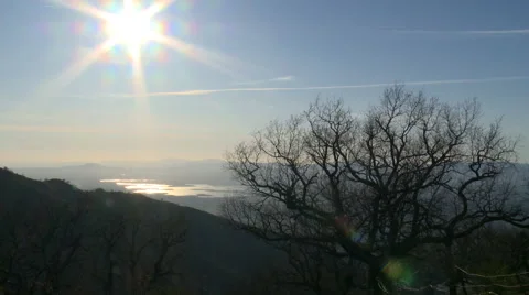 Reservoir lake from the mountain, leafless tree and sun Stock Footage 49653868