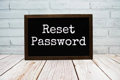 Reset Password text written on chalkboard standing on wooden background 스톡 사진