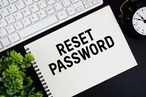 Reset Password text written on notepad with keyboard and alarm clock on bla.. Stock Photos