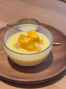Resh mango pudding dessert topped with diced mango cubes Stock Photos