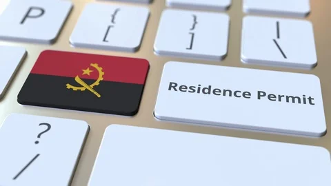 Residence Permit text and flag of Angola on the buttons on the computer keyboard Stock Footage 122993352