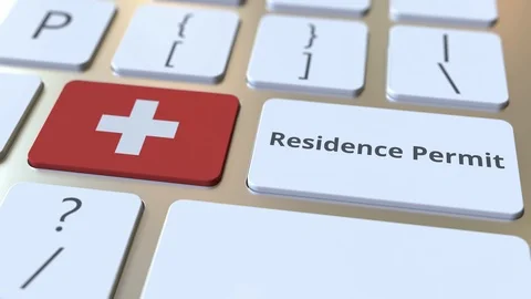 Residence Permit text and flag of Switzerland on the buttons on the computer Stock Footage 123047692