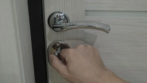 Resident unlocking apartment door Stockbeeldmateriaal 336566681