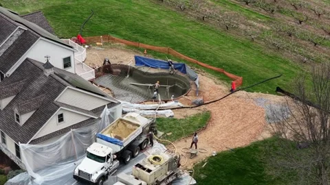 Residential backyard pool construction with gunite process, workers and trucks Stock Footage 333398513