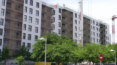 Residential building construction with lifting crane in Madrid Stock Footage 334736692