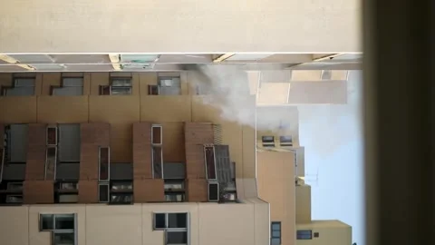 Residential building on fire, flames and smoke breaking out from the window. Stock Footage 316601719
