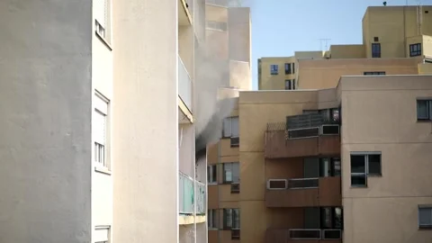 Residential building on fire, flames and smoke breaking out from the window. Stock Footage 316601726