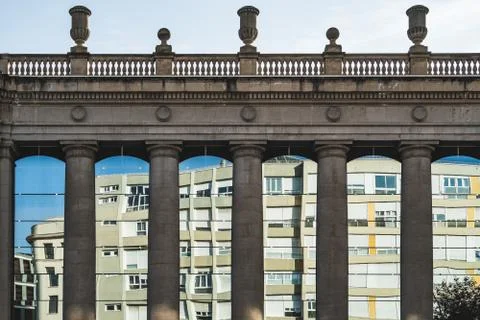 Residential building reflected between doric columns Stock Photos