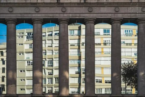 Residential building reflected between doric columns Stock Photos