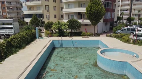 Residential building under construction. In front of the building is a swimmi Stock Footage 199109386