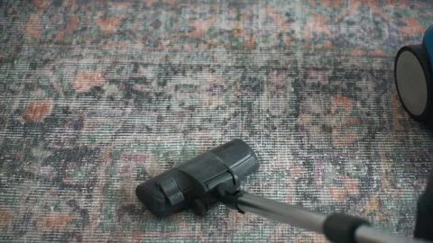 Residential cleaning involves vacuuming dust from carpet fibers carefully Stock Footage 337469396