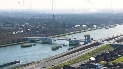 Residential clusters bridge engineering define waterfront scene wind turbines Stock Footage 329072397