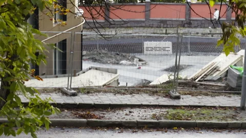 Residential complex construction site driving cars and pedestrian in autumn 스톡 동영상 323867760