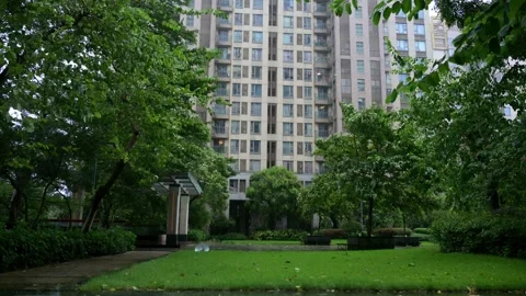 Residential complex garden amid typhoon weather, wet green lawns 스톡 동영상 342500574