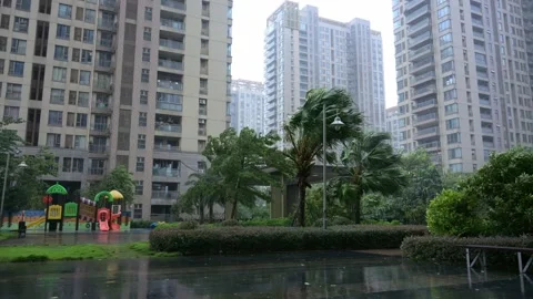 Residential complex garden under strong wind and heavy rain during typhoon 動画素材 346331639
