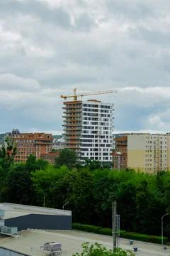 Residential complex under construction with big crane on site. New aparments  Stock Photos