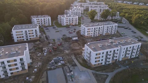 Residential construction site and completed apartment complex in a green Stock-Footage 345010025