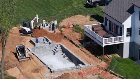Residential construction site with new backyard swimming pool installation Stock Footage 334606422
