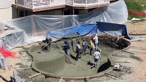 Residential construction workers building custom gunite swimming pool in Stock Footage 333328716
