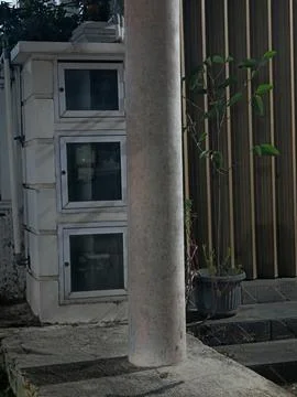 Residential Electrical Meter Boxes on Wall Behind Concrete Pillar Stock Photos