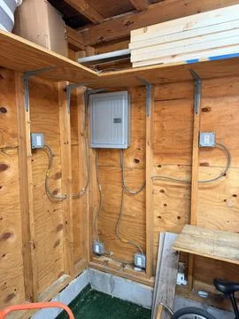 Residential Electrical Panel Installation Surface Mounted Wiring in Garage Stock Photos