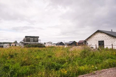 Residential houses under construction in a developing village area with lush Foto stock