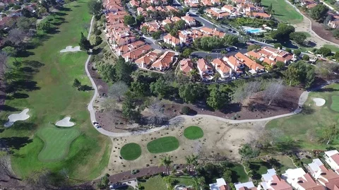 Residential housing on golf course pan to skyline Stock Footage