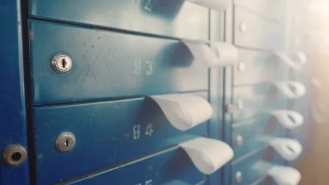 Residential Mailboxes with Utility Payment Bills Sticking Out | Close-Up Shot Stock Footage 329381142