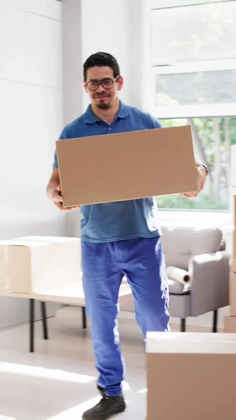 Residential Moving Services. Movers Carrying Boxes Stock Footage 314136763