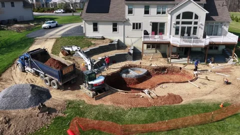 Residential pool construction behind suburban US home with solar panels Stock Footage 333621048