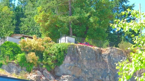 Residential property built on steep rugged rock cliff face Stock Footage 339039487
