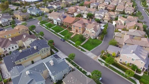 Residential stree aerial pan to city skyline Stock Footage 86253376