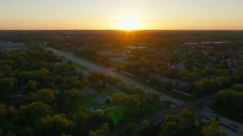 Residential Subdivision Under Full Canopy as the Sun Drops Over Lake County Stock Footage 345996279
