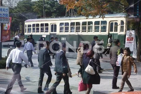 Residents of Seoul South Korea walk in front of preserved old traincar - Seoul Stock Photos