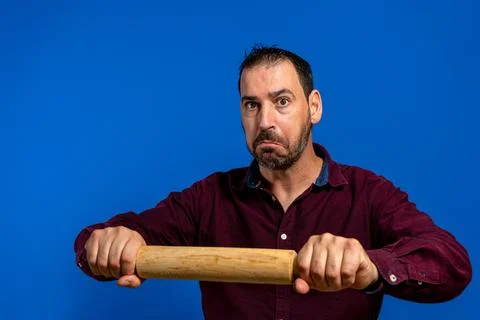Resigned hispanic man with a beard executing the kneading gesture with a wood Foto stock