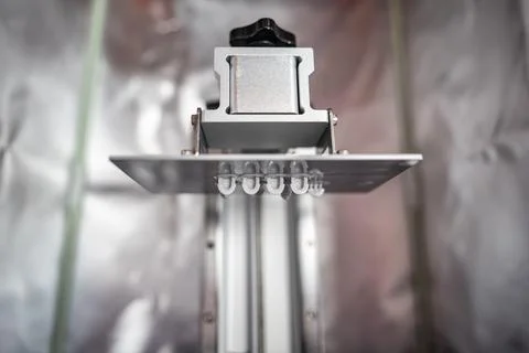 Resin 3d printer head that prints the models underneath hanging from the head. Stock Photos