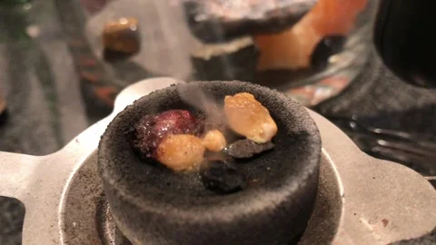 Resin chunks smoldering on a charcoal disc Stock Footage 336442620