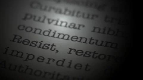 Resist and restore.. Moving text printed on a page. Slow motion. Stock Footage 307286197