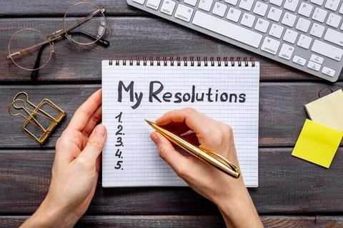 Resolutions hand writing list in notepad - inspirational and motivating concept Stock Photos