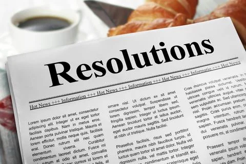 Resolutions in newspaper layout on a breakfast table with a blurry cup of c.. Stock Photos