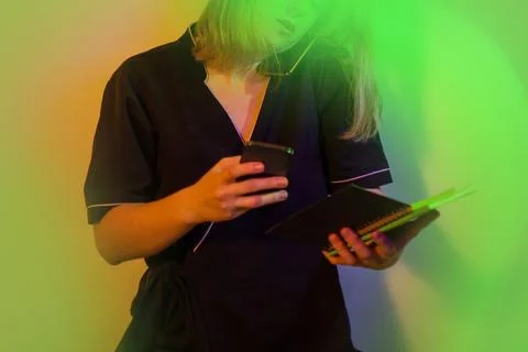 Resolves work issues using two phones. Portrait of woman uses two phones to c Stock Photos