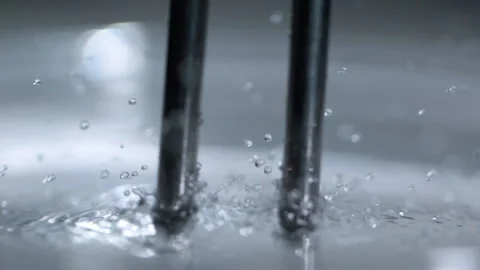 Resonance and frequency tuning fork slow motion water droplets Stock Footage 147223423