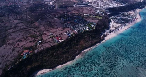 Resort on beach in front of shallow reef with turquoise water Stock Footage 116083311