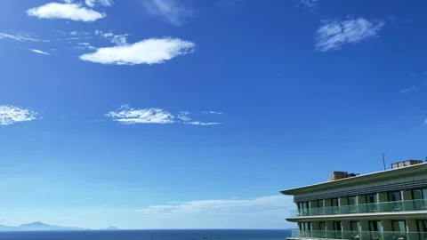 A resort building built next to the blue sky and the sea Stock Footage 277496283